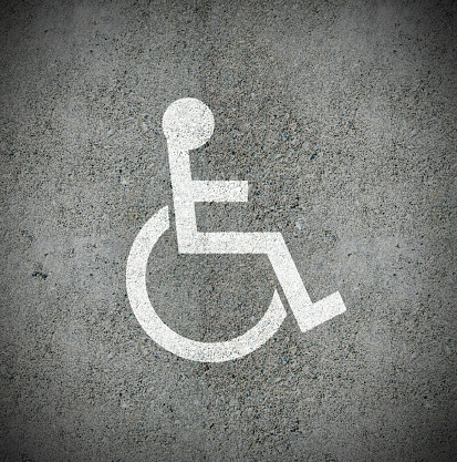 Disabled parking symbol painted on asphalt