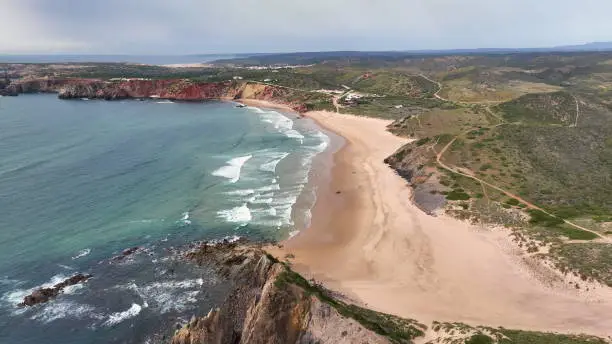 Photo of Aerial view of the Waves in the Atlantic Ocean at the Carrapateira. red mountains and Algarve coast Travel Europe Portugal