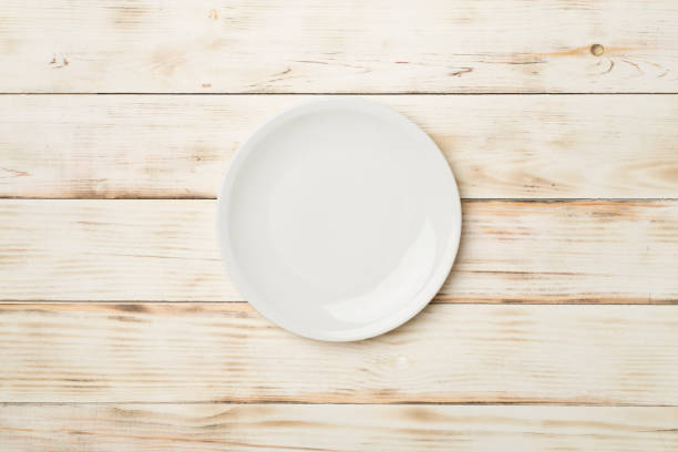 istock Empty round plate on wooden background, top view 1497008072
