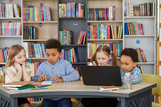 istock Multiracial group of children sitting in row at school classroom and using laptops. Back to school. 1497012461