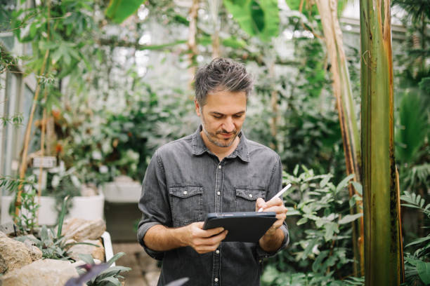 istock man uses digital tablet for his botany research 1497013892