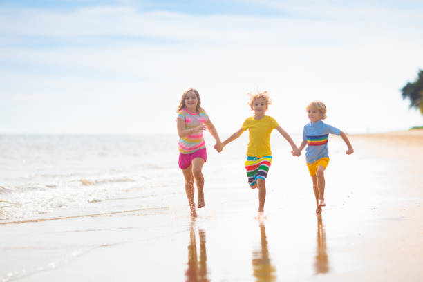 istock Kids play on tropical beach. Sand and water toy. 1497014044