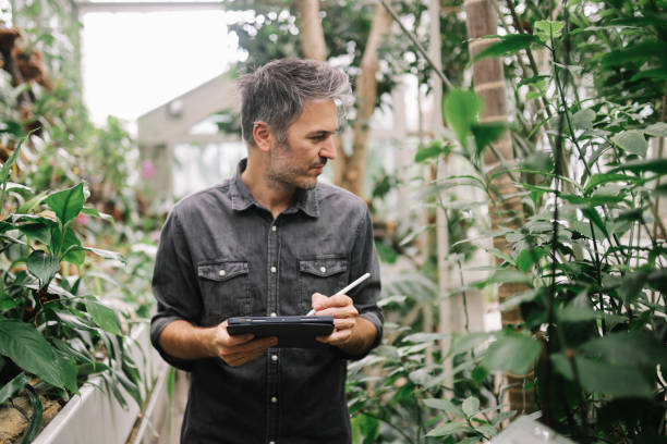 istock man uses digital tablet for his botany research 1497014274