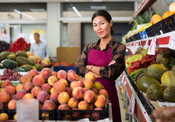 istock Greengrocer worker standing in salesroom 1497015859