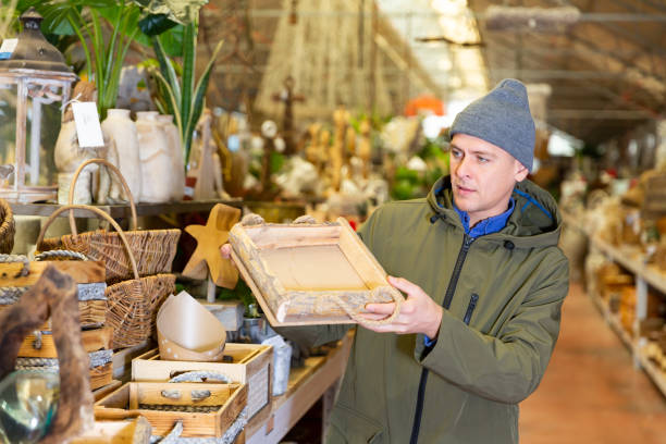 istock Man choosing wooden box in decorative goods store 1497016438