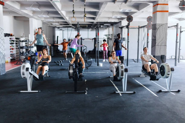 istock Fit people working out in the gym with rowing machine 1497019645