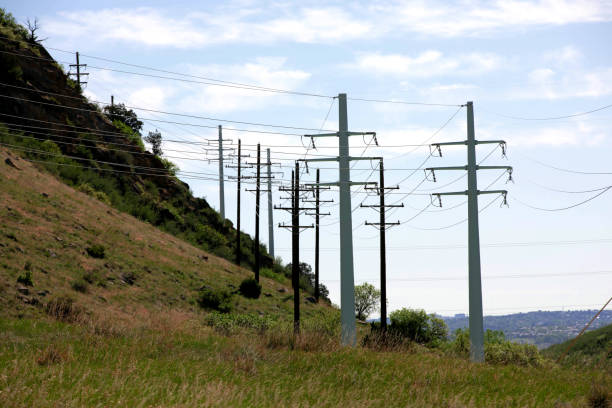 istock Electrical power lines in mountains against blue sky 1497019758