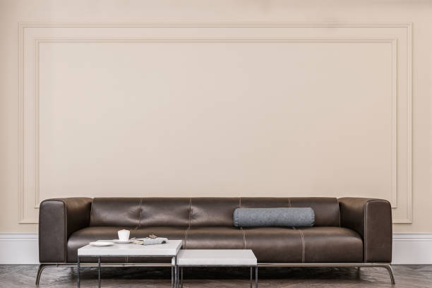 istock Cozy retro-chic interior with a black leather cushion sofa, paneled wall with moldings, 50s- 60s decoration 1497020310