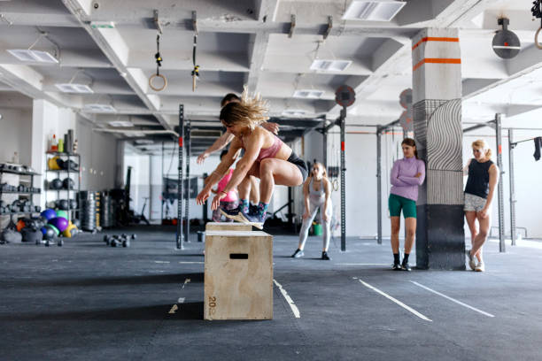 istock Two people doing a box jump overs in the gym 1497023919