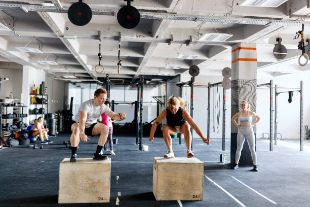 istock Strong and motivated people doing box jumps in the gym 1497023921