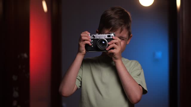 portrait of a boy taking pictures on an old vintage camera