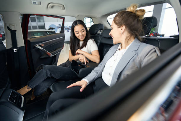 istock Two happy women at back seats in car 1497028824