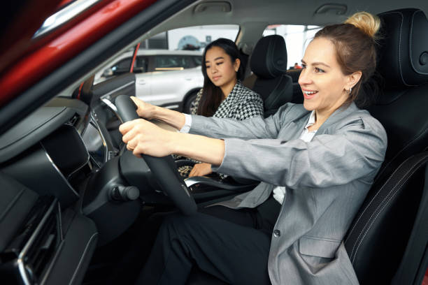 istock Two happy women sitting inside a car 1497028830
