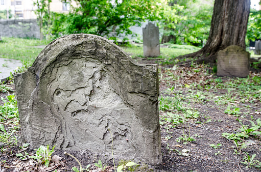 A small private firm that produces gravestones exposes samples of its products along the sidewalk