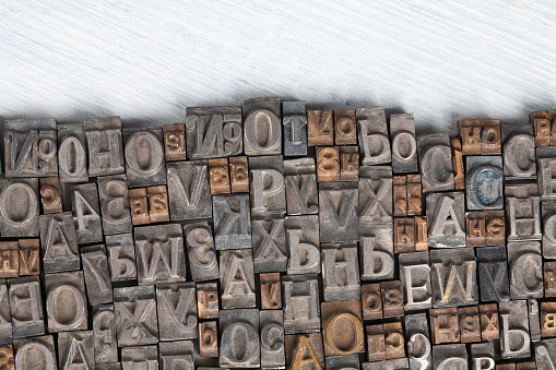Antique vintage movable type alphabet set on wooden deck