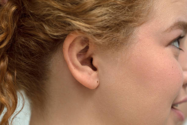 Close up female ear Close up female ear Earlobe stock pictures, royalty-free photos & images