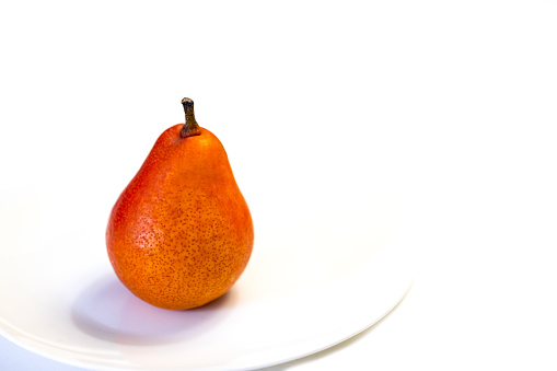 Australian Piga Boo pear, white background with copy space, full frame horizontal composition