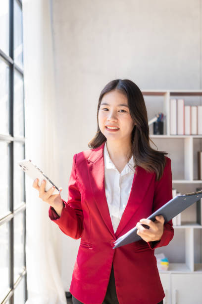 istock Woman using mobile phone to talk with colleagues while working in office Attractive businesswoman using mobile phone to talk with colleagues and business partners 1497055514