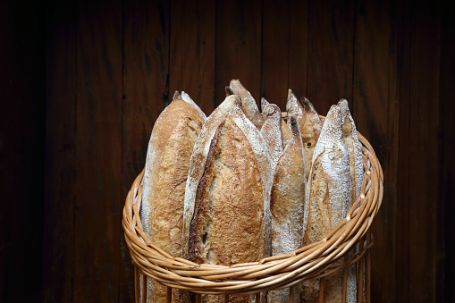 fresh baguettes in wicker basket at bakery
