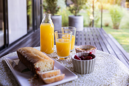 Breakfast with oatmeal with berries and nuts, croissants, toasts with jam and butter, coffee and orange juice