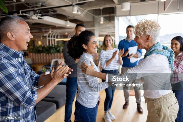 Boss Giving Woman A Promotion At The Office And Team Clapping For Her Stock Photo - Download Image Now
