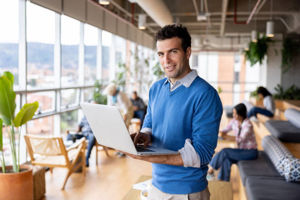 istock Happy businessman working on his laptop at a coworking office 1497057708