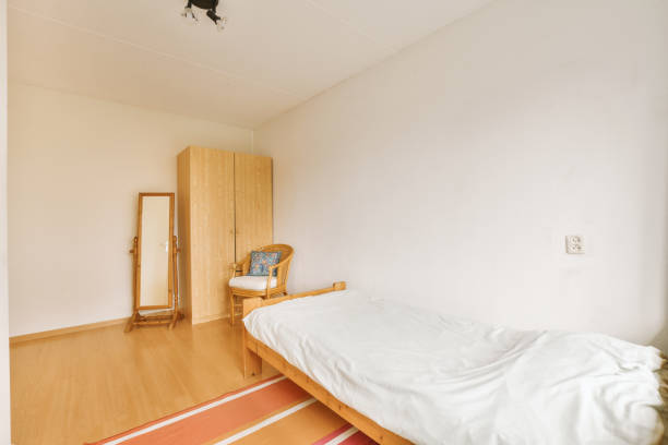 istock a room with a bed and a chair in it 1497057826