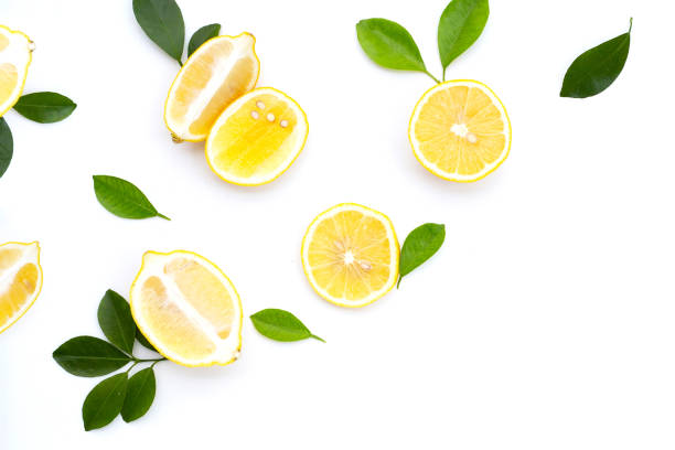istock Fresh lemon with green leaves on white. 1497058780