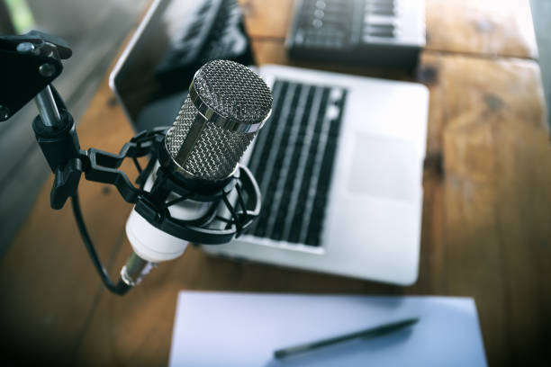 istock Close up a microphone with the laptop in the background, Home studio concepts. 1497058918