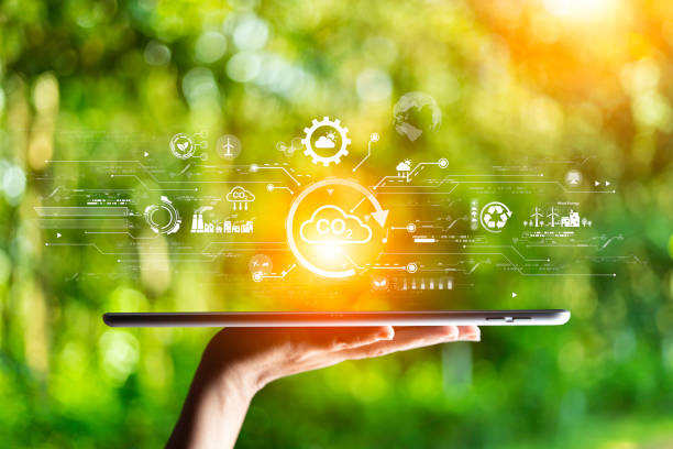 istock green energy concept help reduce global warming.Hand holding natural background light bulb on green leaf with clean energy icon around it. Carbon dioxide emission in industry zero carbon concept. 1497059751