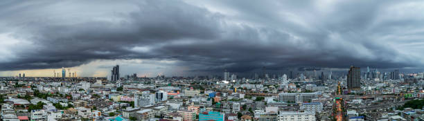 A heavy storm with rain and dramatic atmosphere clouds panoramic shot can be a sight to behold over a city center. stock photo