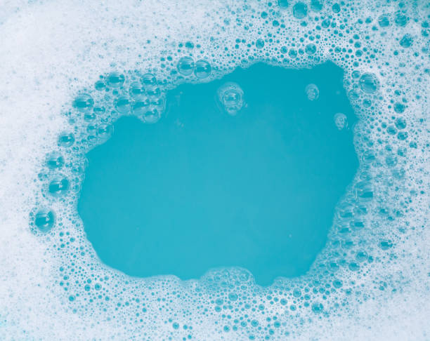 istock Detergent foam bubble on water. Blue background, Soap sud 1497064581
