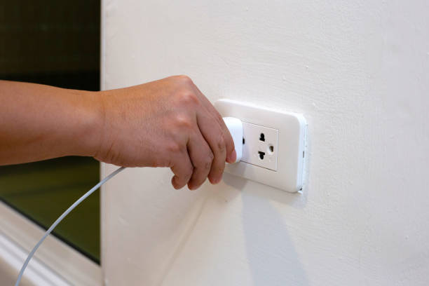 istock Hand insert a plug of the phone charger into socket. 1497069864