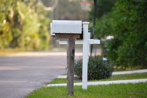 Typical american outdoors mail box on suburban street side.