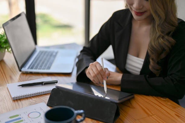 istock A businesswoman using her digital tablet at her desk in the office. 1497071626
