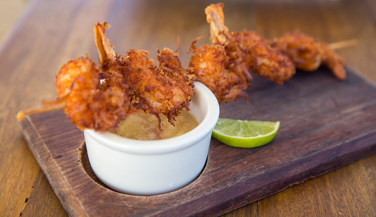 Coconut shrimp skewer with pineapple sauce for dipping