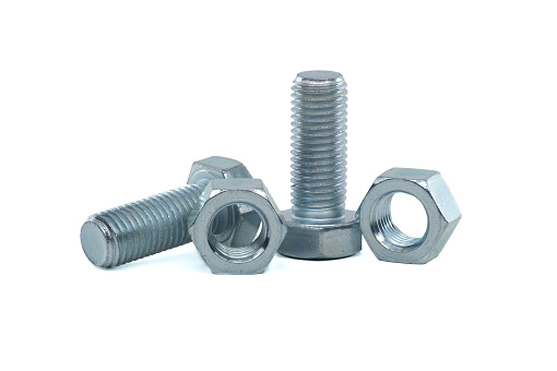 Male screws and hexagon nuts coated with a protective layer of zinc isolated on white background