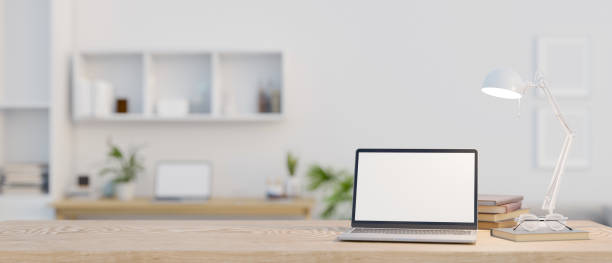 istock Minimalist workspace with laptop mockup on a wooden tabletop in a minimal white office. 1497075430