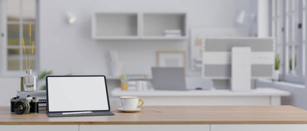 istock Workspace with digital tablet mockup and copy space on a tabletop in modern white office. 1497075433