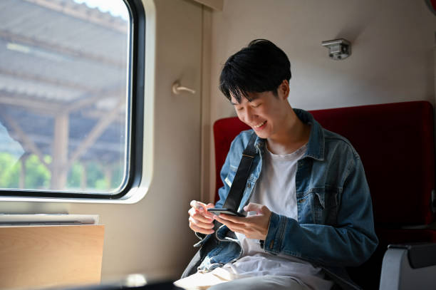 istock A male traveler backpacker using his smartphone while sitting in his seat on a train. 1497076101
