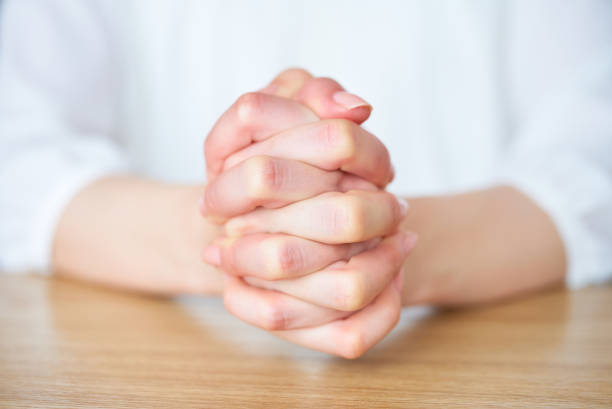 istock Hands of a woman who thinks with her hands folded 1497076194
