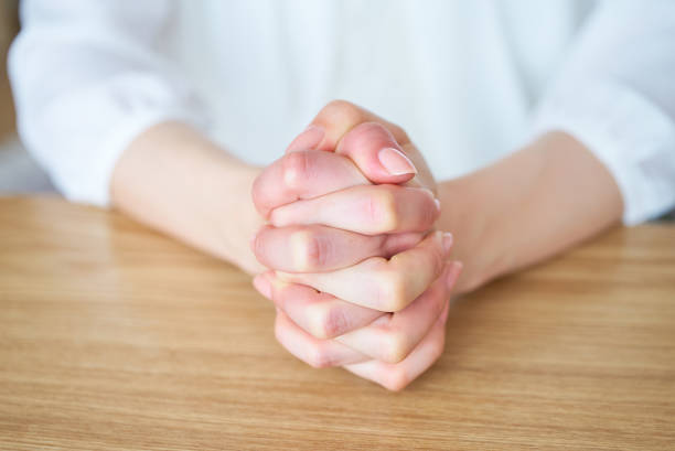 istock Hands of a woman who thinks with her hands folded 1497076213