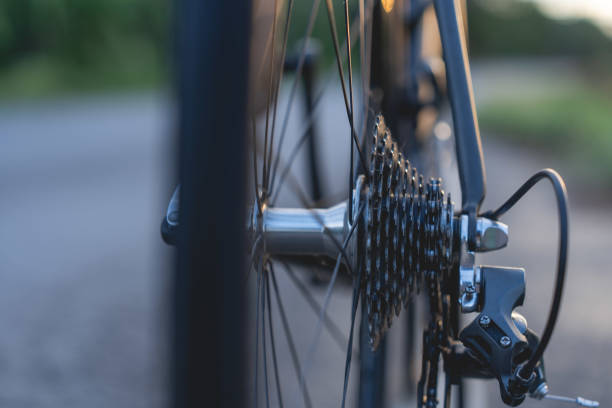 istock Road bike parked on a beautiful road sunset, warm light with copy space. 1497076287