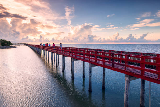 Red bridge (Saphan Daeng) in the beautiful sunrise, popular tourist destination, Samut Sakhon, Thailand stock photo