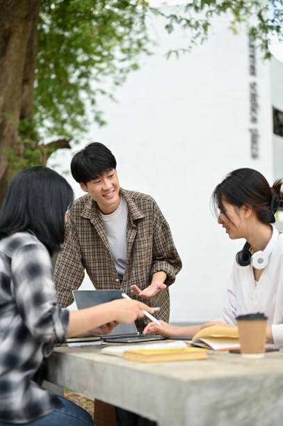 istock A male college student is discussing work with his friends and sharing his ideas 1497078040