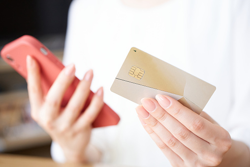 Woman's hand with credit card and smartphone