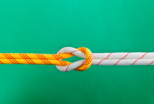 Reef knot on green background.