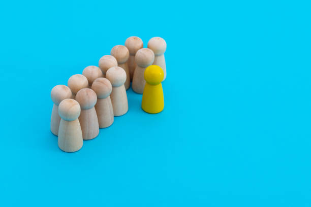 Yellow one standing out from the wooden figures