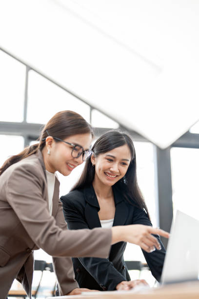 istock Two Young smiling businesswoman discuss with new startup project Idea presentation and investment market at office. 1497086056