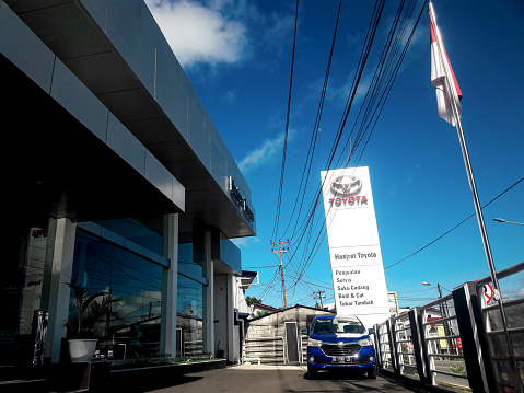 Ambon, Indonesia - June 9, 2023 : There is a blue car parked in front of the Toyota dealer building